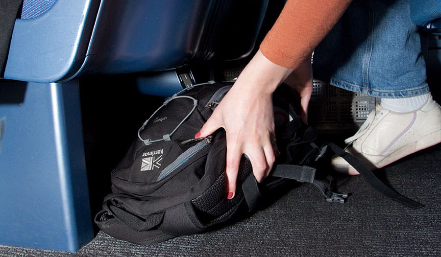Passenger storing a backpack under the seat