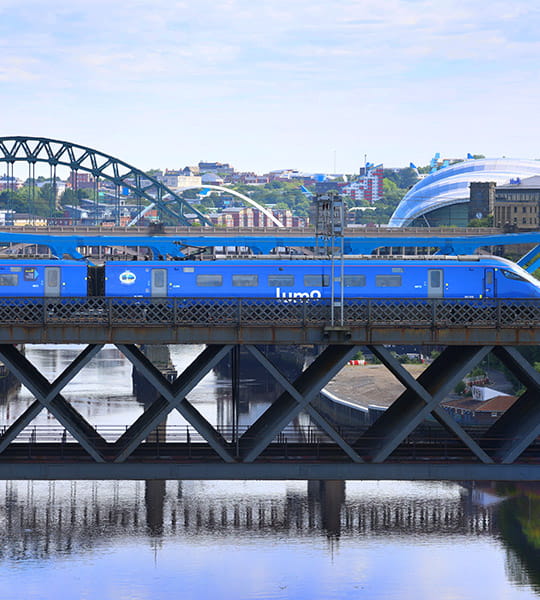 Lumo train passing over the Tyne bridge