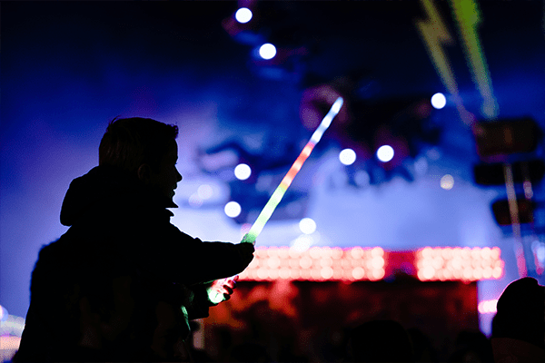 Silhouette of a child in front of light show