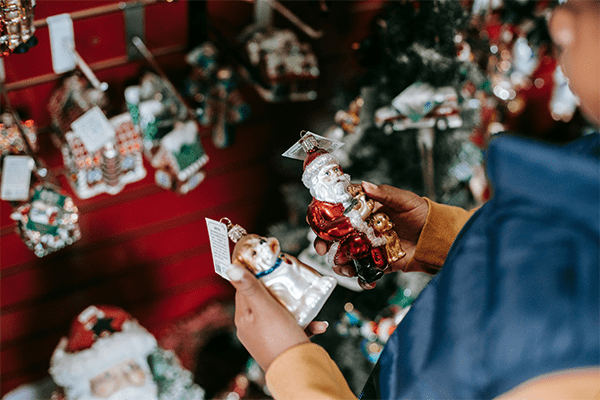 child looking at Christmas ornaments