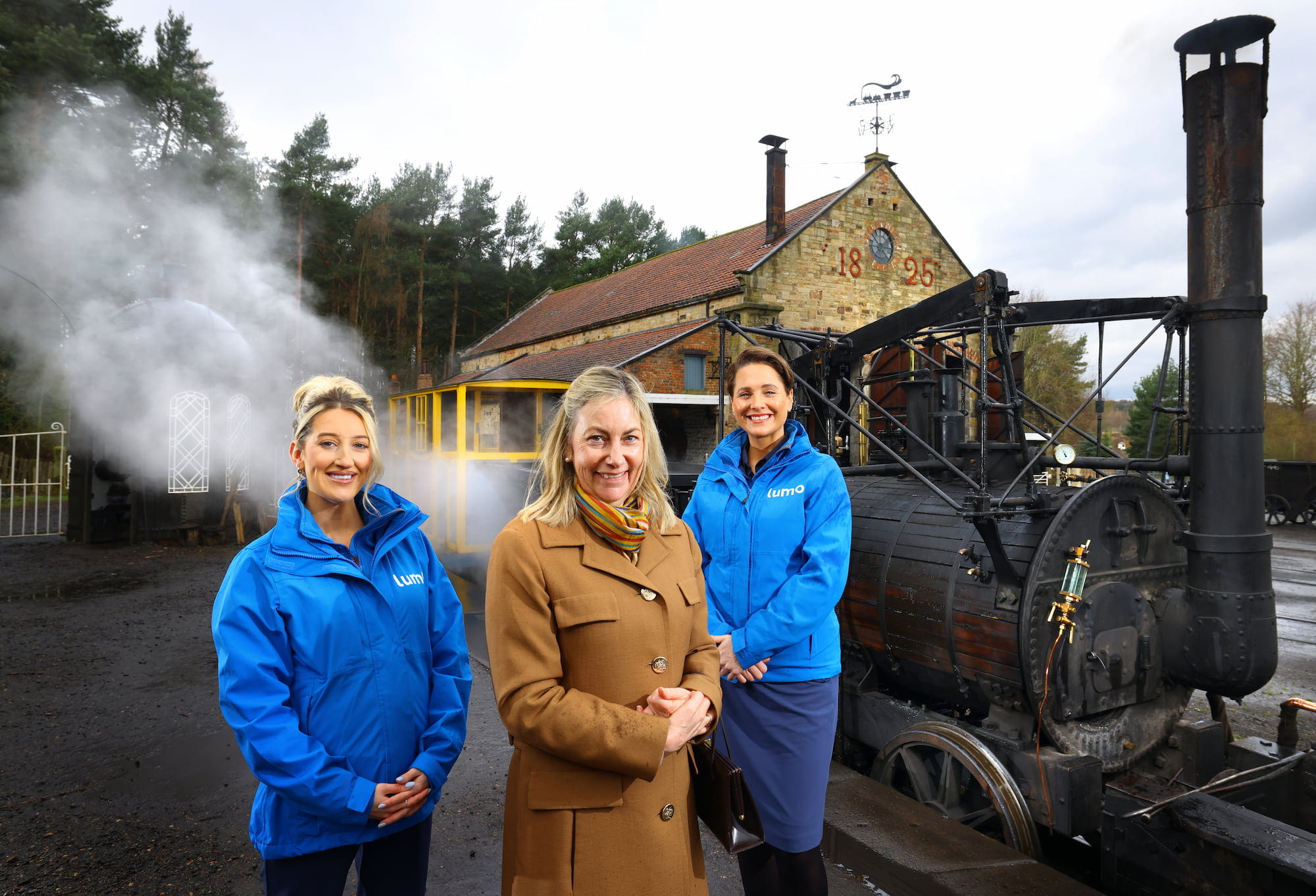 lumo staff with old train outside a station